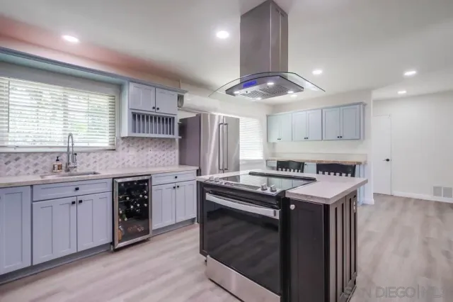 a kitchen with stainless steel appliances granite countertop a stove and a sink