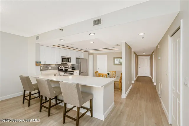 a kitchen with counter top space cabinets and bed