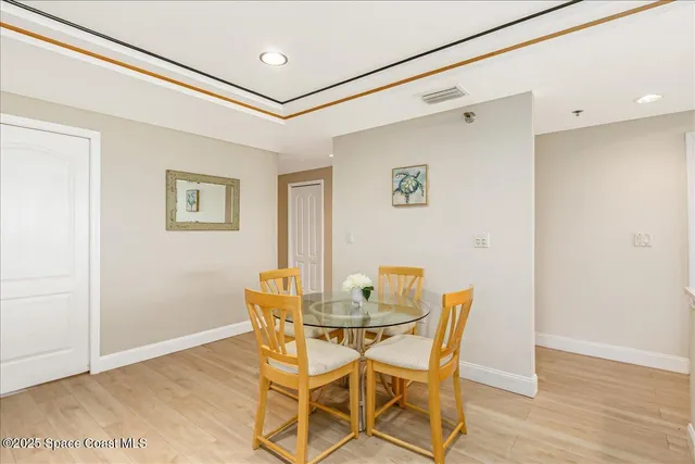 a kitchen that has a lot of cabinets and wooden floor