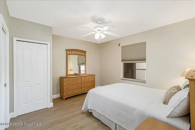 a bedroom with a bed and a flat tv screen on the dresser