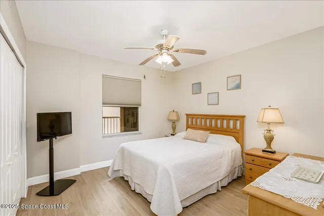 a view of a hallway with wooden floor and entryway