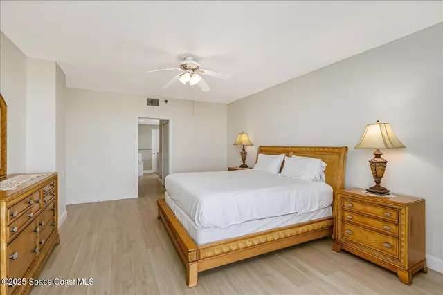 a bedroom with a bed and a night stand