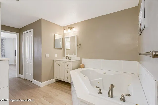 a bathroom with a double vanity sink a toilet and a mirror