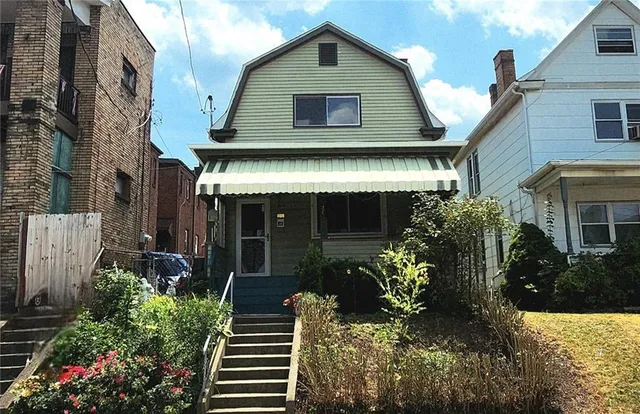 a front view of a house with garden