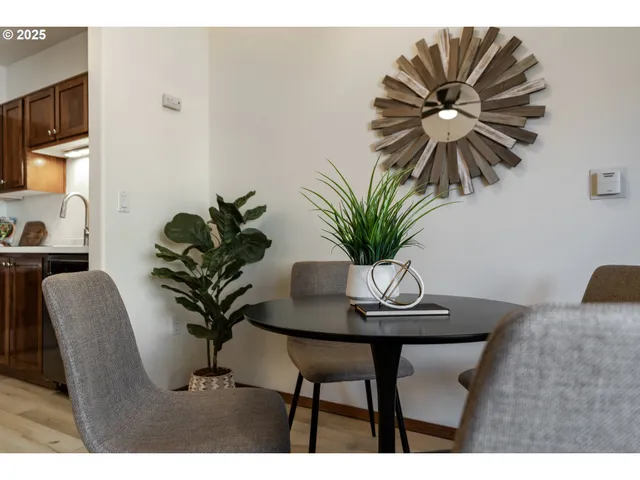 a dining room with furniture and a potted plant