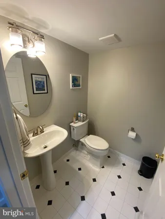 a bathroom with a sink mirror and toilet