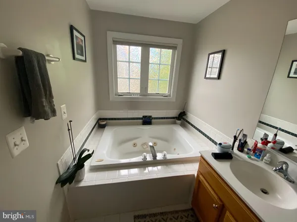 a white bath tub sitting in a bathroom next to a window