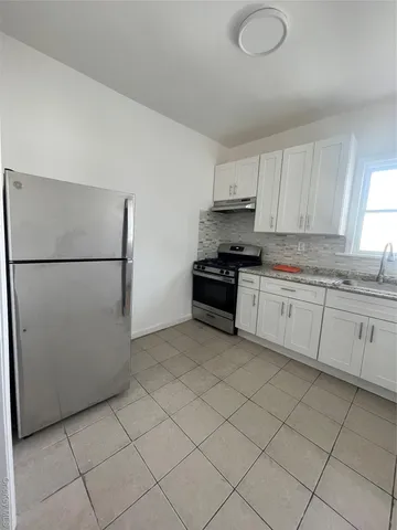 a kitchen with a sink a stove and refrigerator