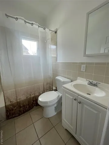 a bathroom with a sink a toilet and bathtub
