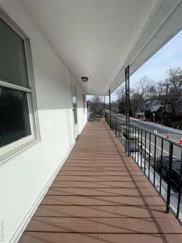 a view of balcony with wooden floor