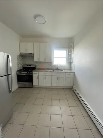 a view of a room with wooden floor and window