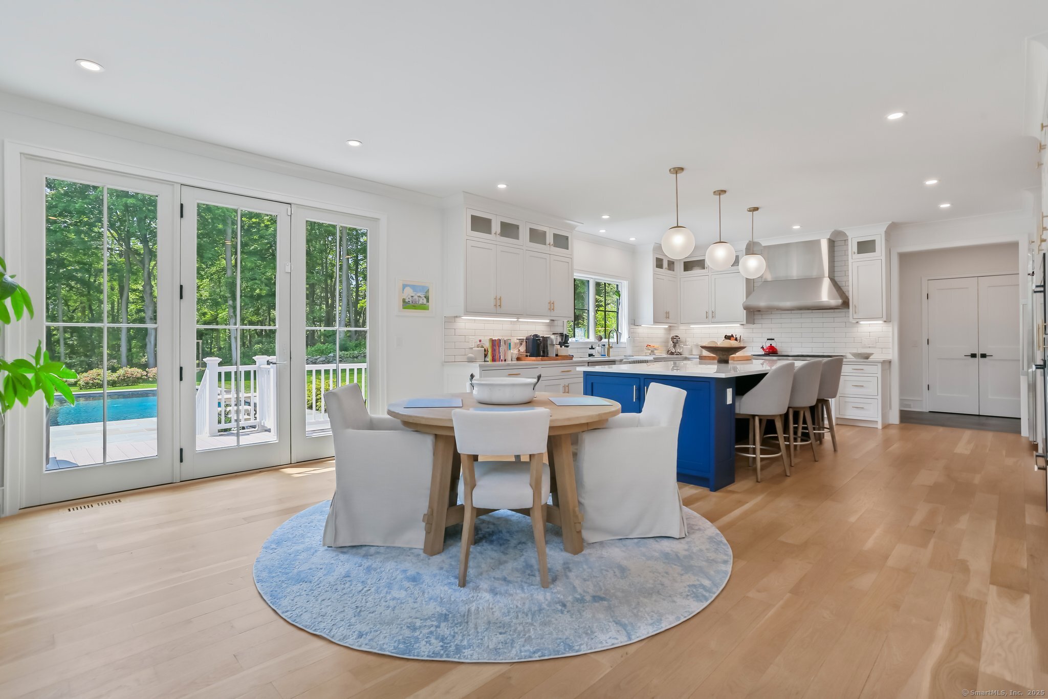 2015 Redding Road Fairfield, CT 06824 - Photo 11 of 40 a dining room with a table chairs and a kitchen view