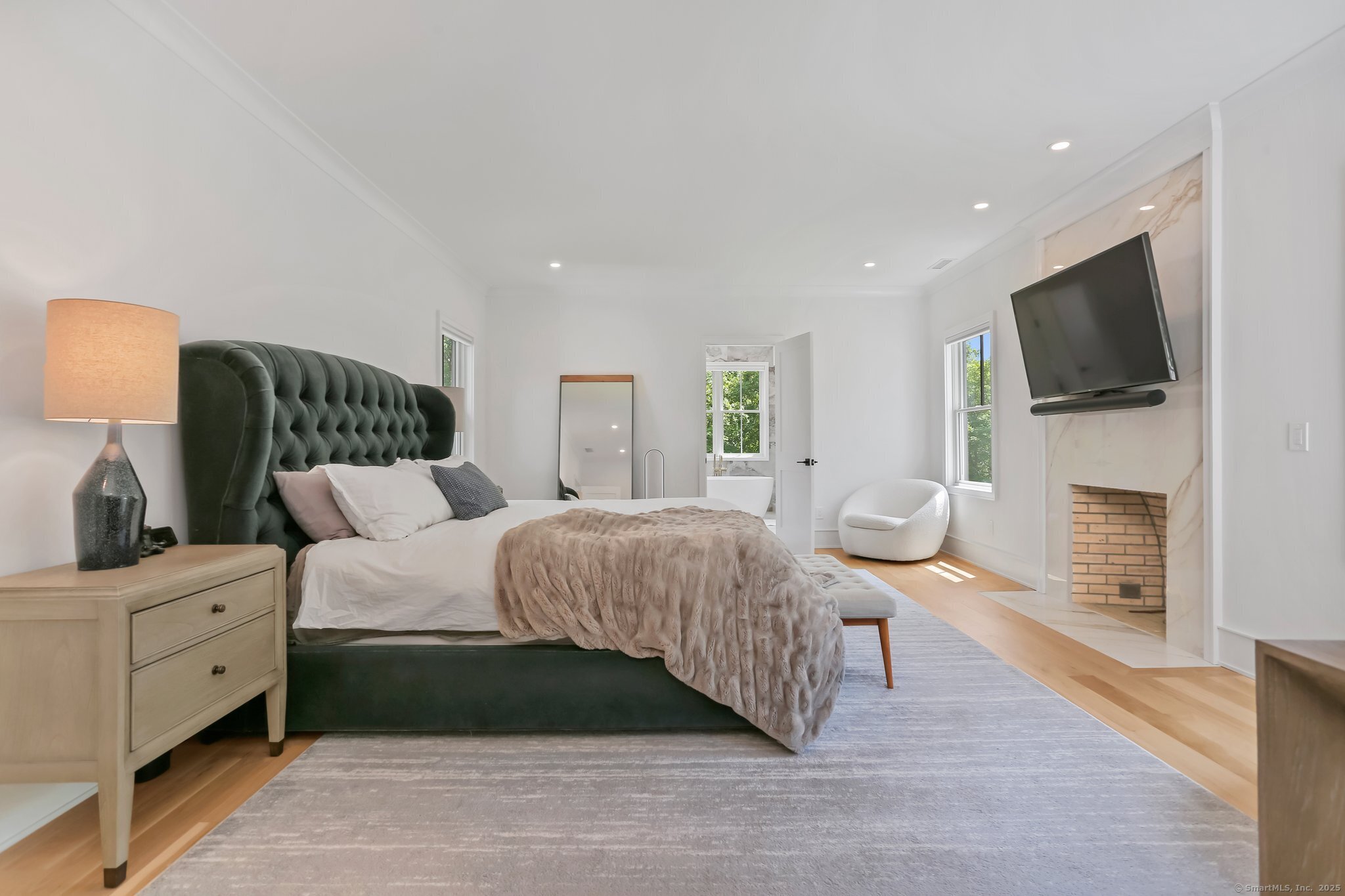 2015 Redding Road Fairfield, CT 06824 - Photo 18 of 40 a bedroom with a large bed and a flat screen tv