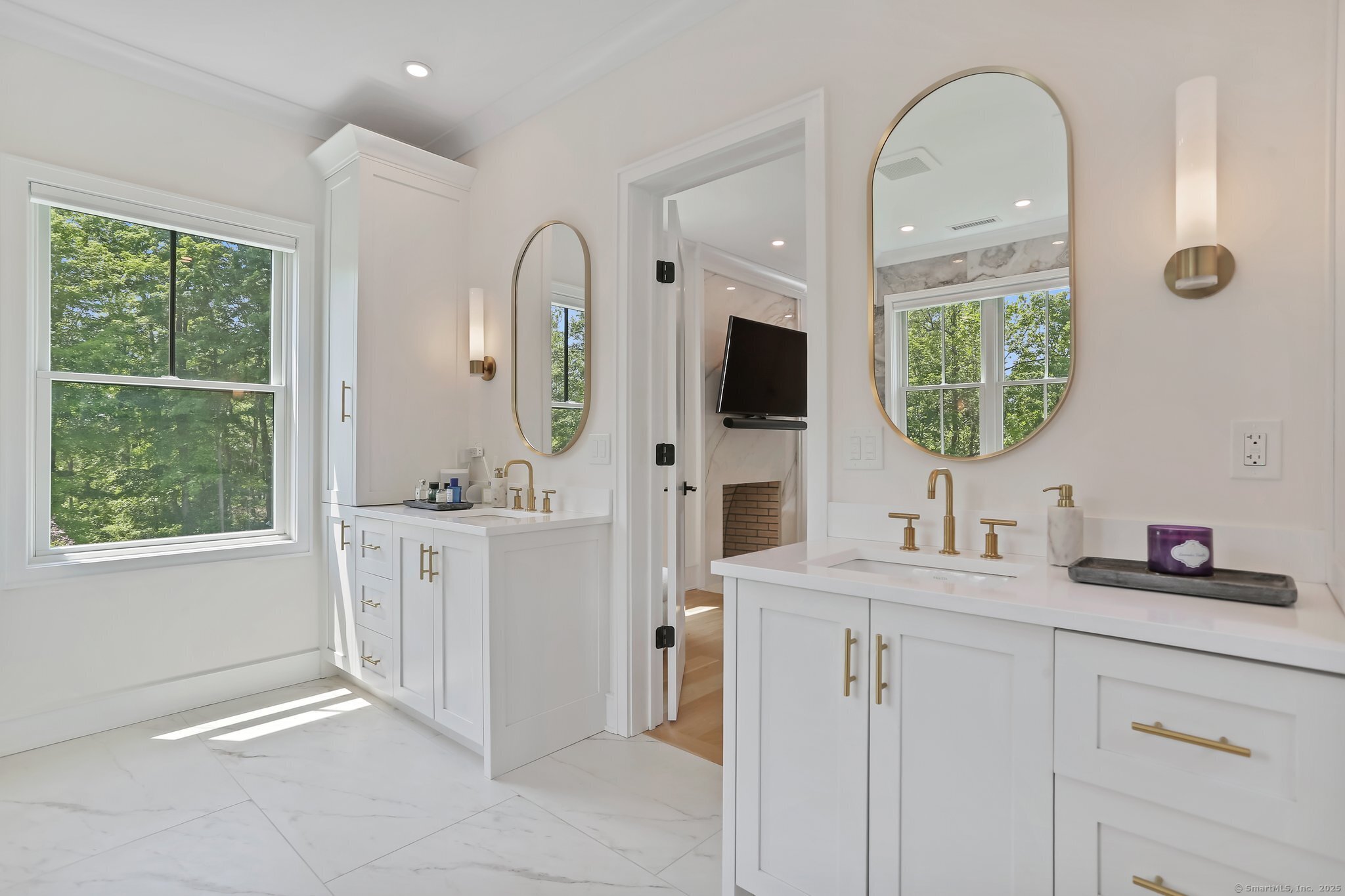 2015 Redding Road Fairfield, CT 06824 - Photo 22 of 40 a bathroom with a double vanity sink and mirror with window