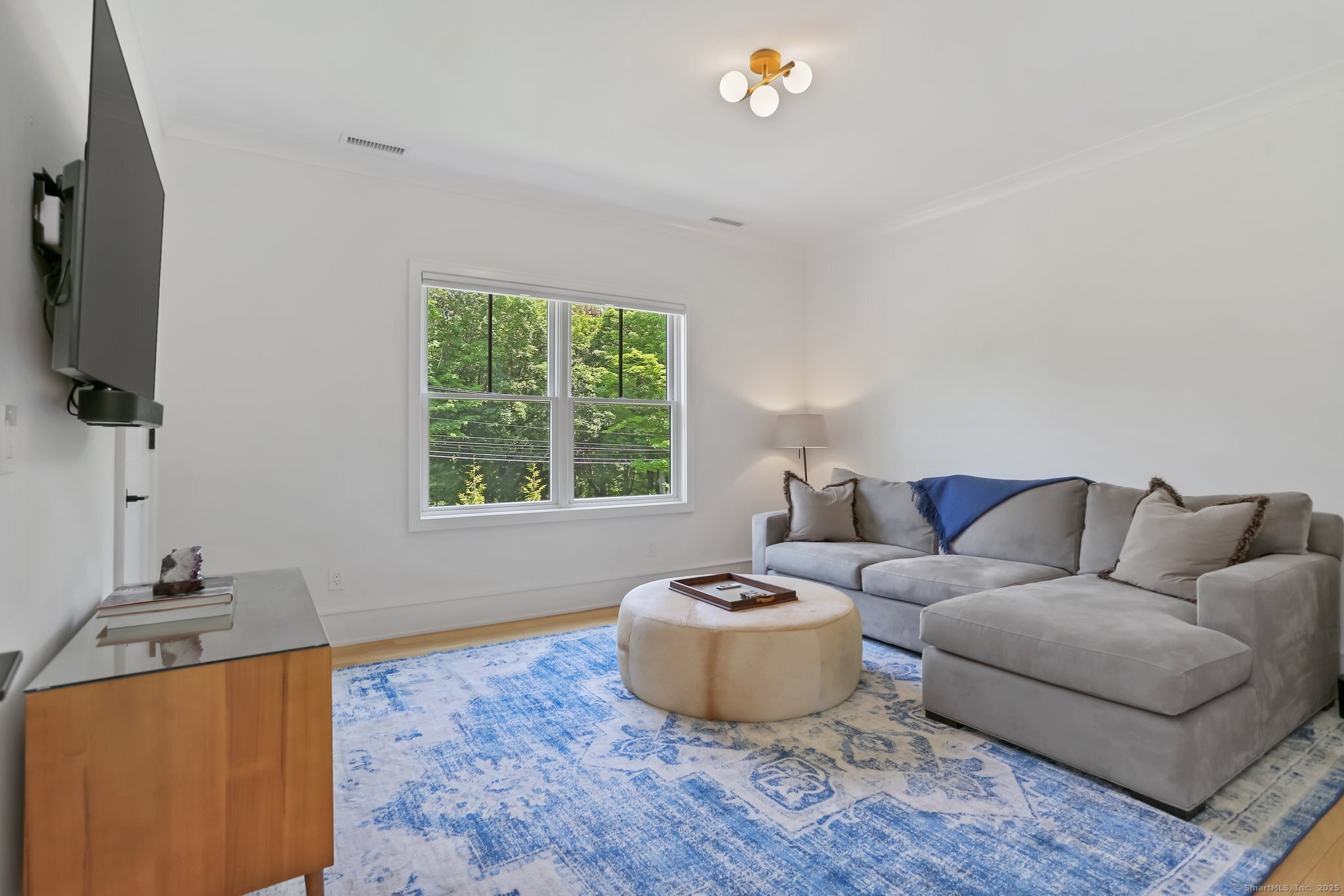 2015 Redding Road Fairfield, CT 06824 - Photo 24 of 40 a living room with furniture and a flat screen tv