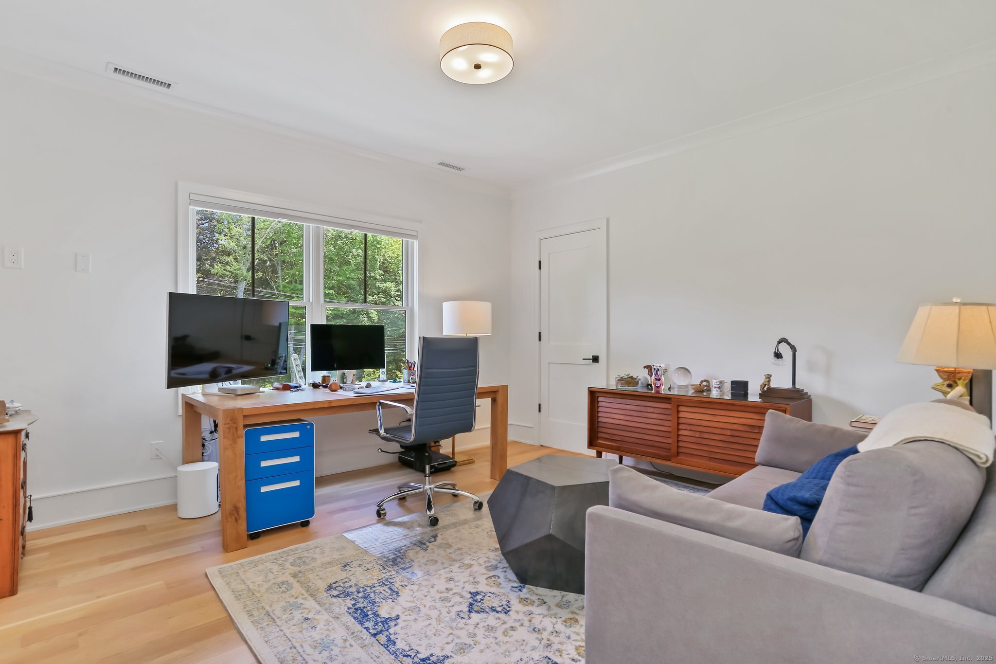 2015 Redding Road Fairfield, CT 06824 - Photo 26 of 40 a living room with furniture and a flat screen tv