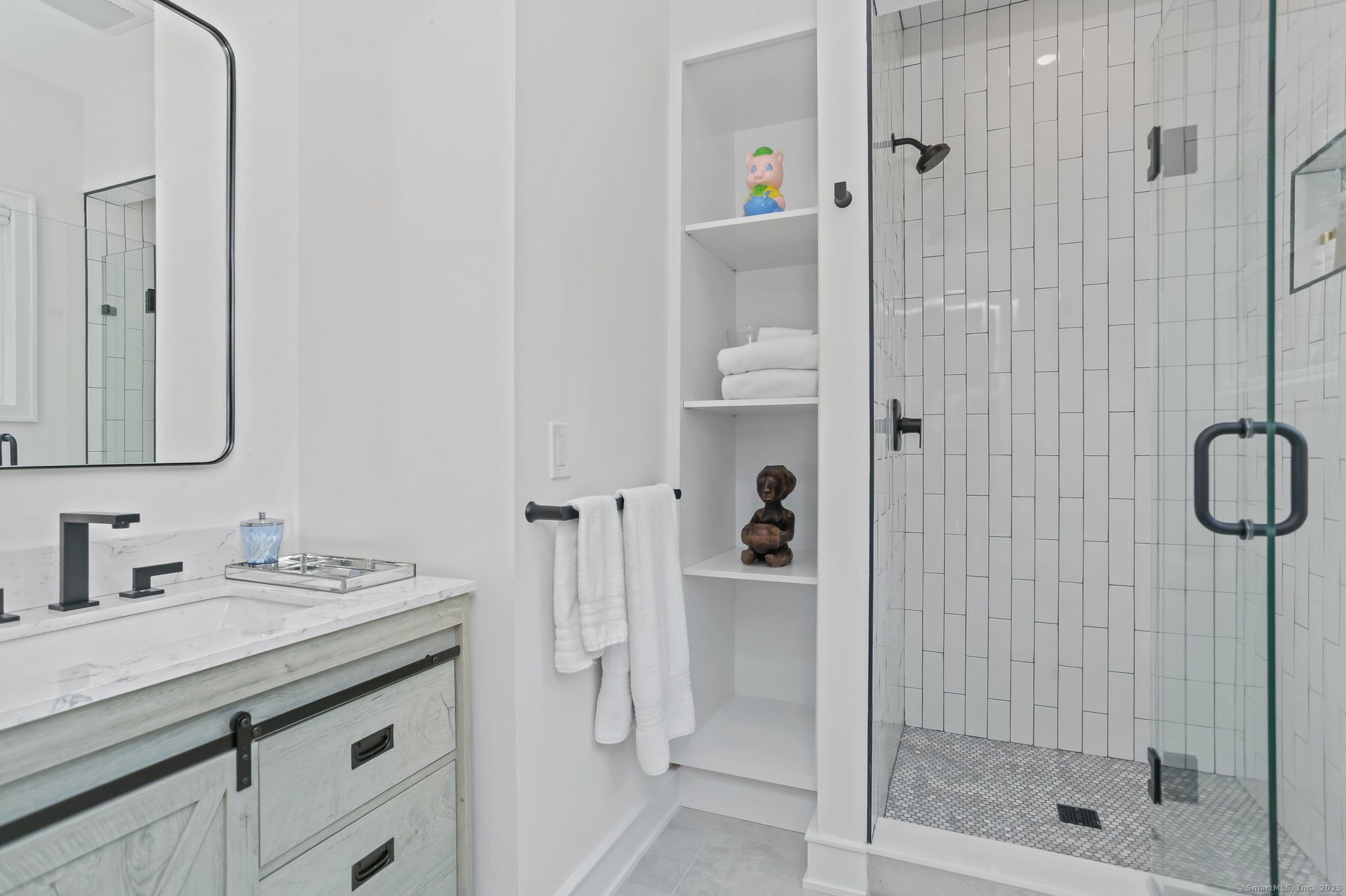 2015 Redding Road Fairfield, CT 06824 - Photo 28 of 40 a bathroom with a shower sink and mirror