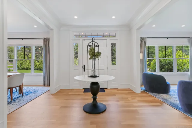 a living room with fireplace furniture and a large window