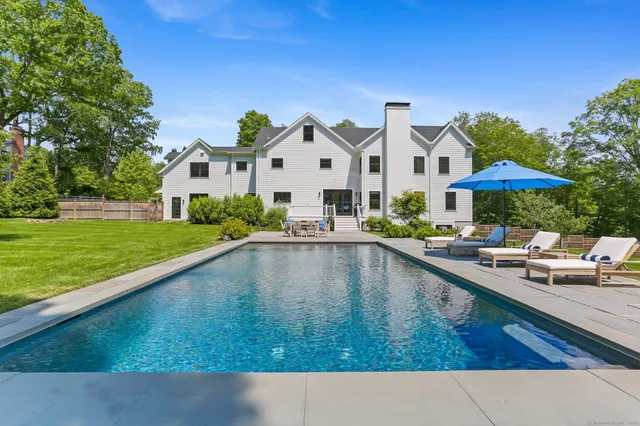 a swimming pool view with a outdoor seating