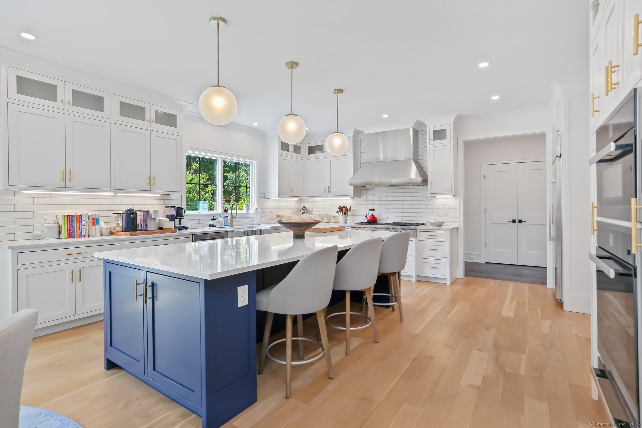2015 Redding Road Fairfield, CT 06824 - Photo 7 of 40 a kitchen with kitchen island granite countertop a sink a center island and cabinets