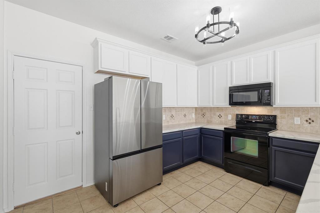 6000 Lost Valley Drive The Colony, TX 75056 - Photo 10 of 40 a kitchen with stainless steel appliances granite countertop a refrigerator and a stove top oven