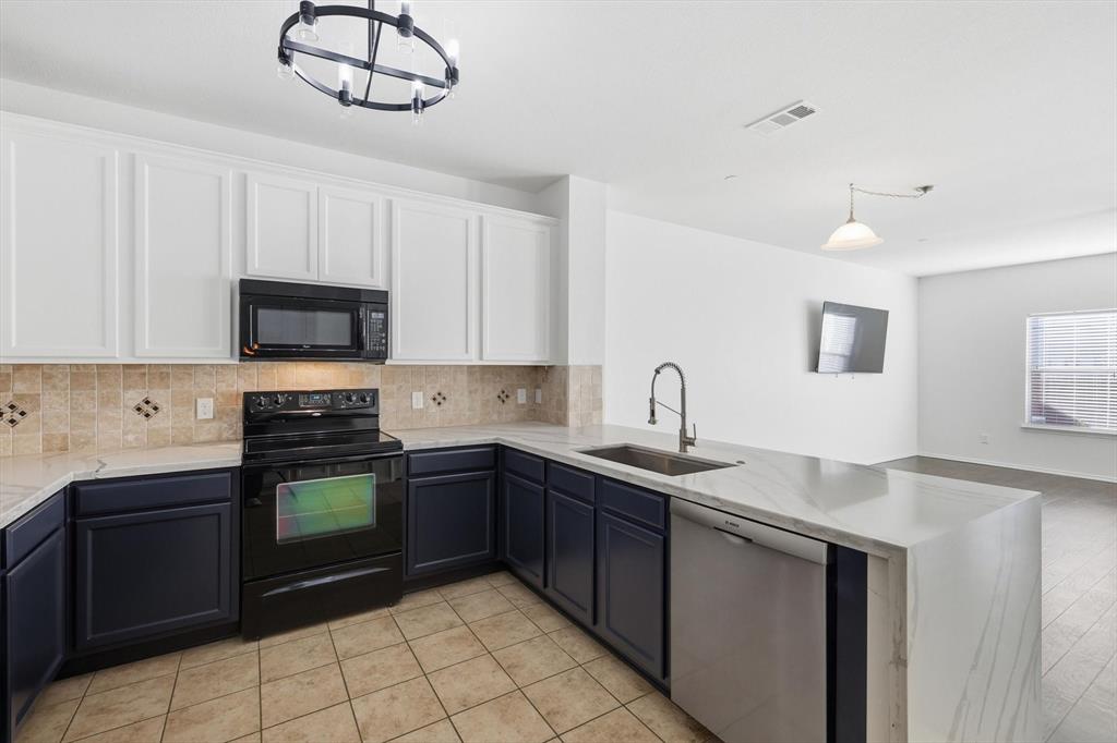 6000 Lost Valley Drive The Colony, TX 75056 - Photo 11 of 40 a kitchen with a sink appliances and cabinets