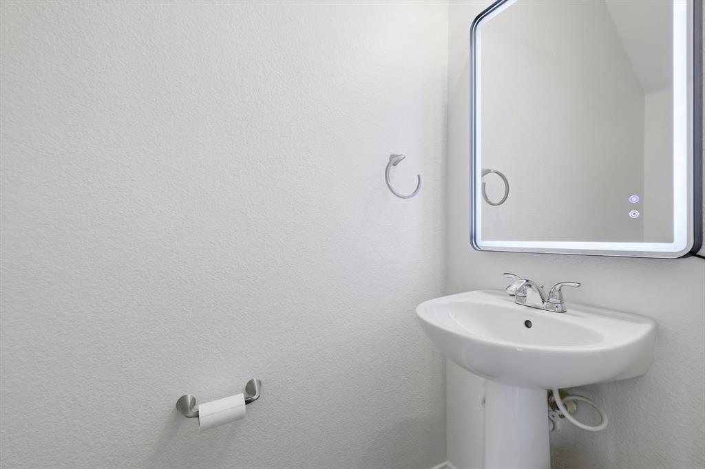 6000 Lost Valley Drive The Colony, TX 75056 - Photo 16 of 40 a bathroom with a sink and mirror