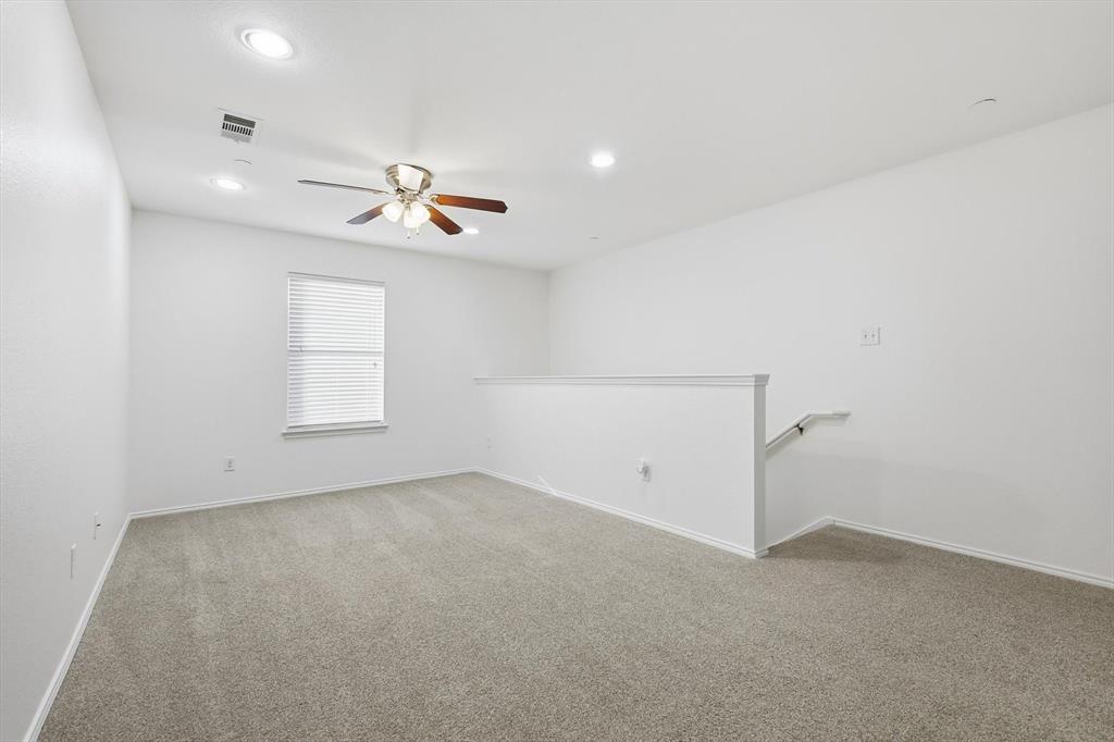 6000 Lost Valley Drive The Colony, TX 75056 - Photo 19 of 40 wooden floor in an empty room with a window