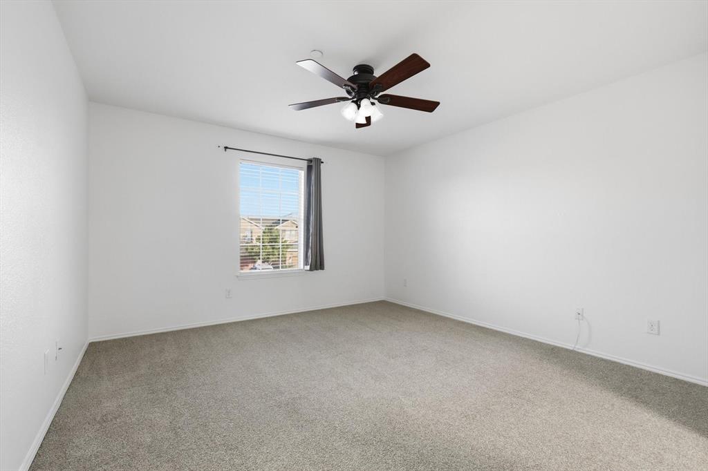 6000 Lost Valley Drive The Colony, TX 75056 - Photo 21 of 40 an empty room with a window and a ceiling fan