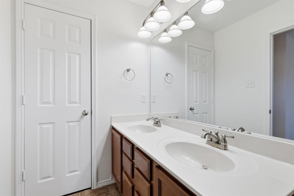 6000 Lost Valley Drive The Colony, TX 75056 - Photo 23 of 40 a bathroom with a sink vanity and a mirror