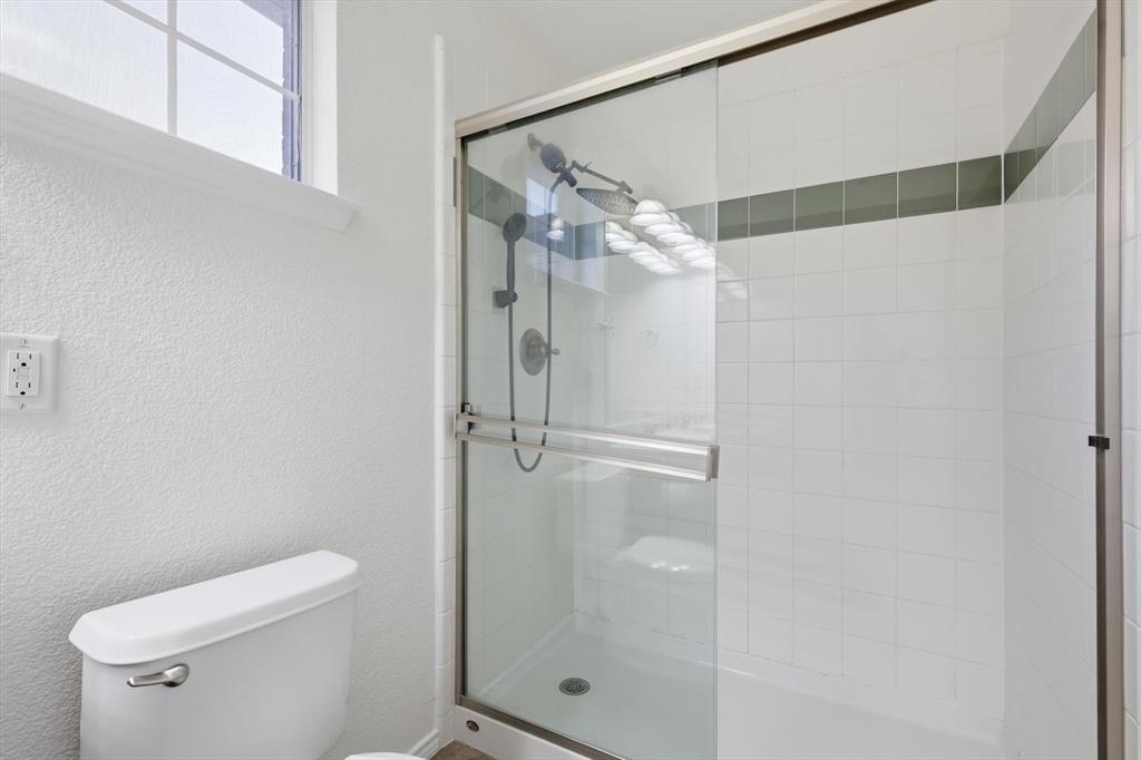 6000 Lost Valley Drive The Colony, TX 75056 - Photo 26 of 40 a bathroom with a shower a toilet and sink