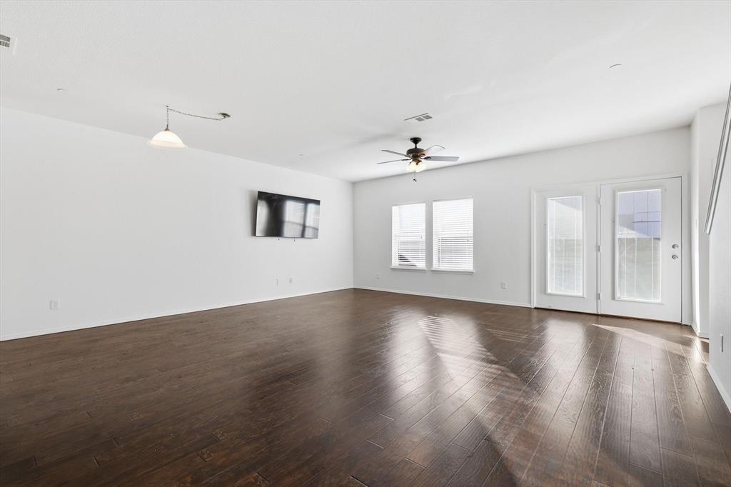 6000 Lost Valley Drive The Colony, TX 75056 - Photo 4 of 40 a view of an empty room with a window and wooden floor