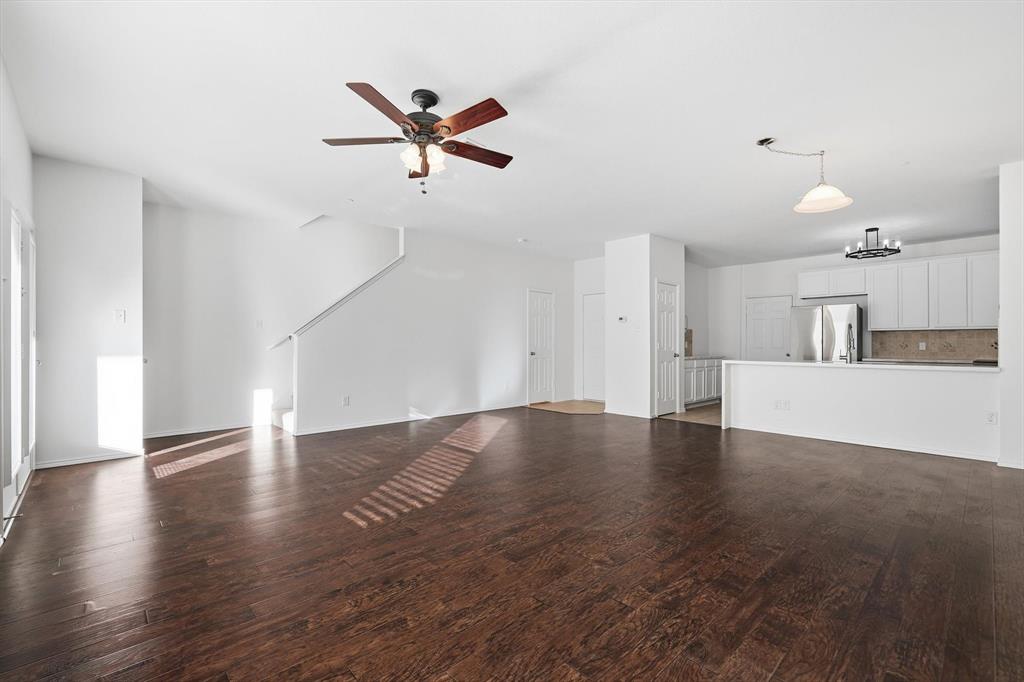 6000 Lost Valley Drive The Colony, TX 75056 - Photo 39 of 40 a view of a livingroom with wooden floor and a ceiling fan
