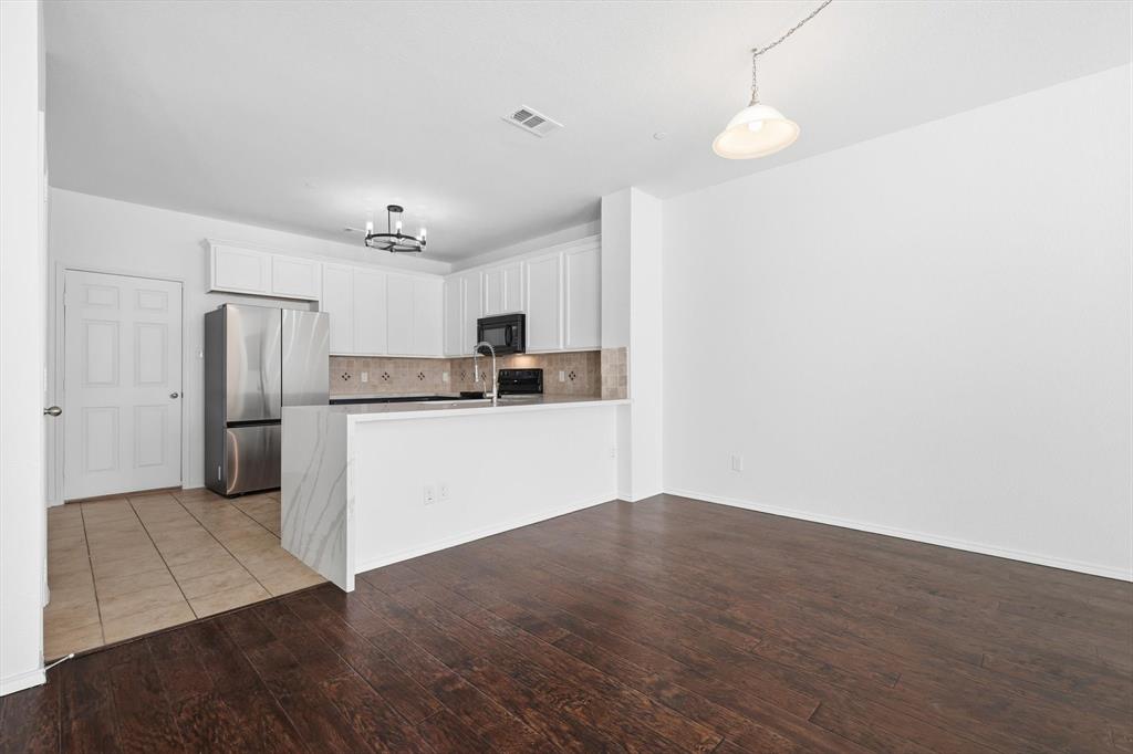 6000 Lost Valley Drive The Colony, TX 75056 - Photo 8 of 40 a kitchen with stainless steel appliances a refrigerator and a sink