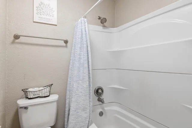 a bathroom with a shower and toilet