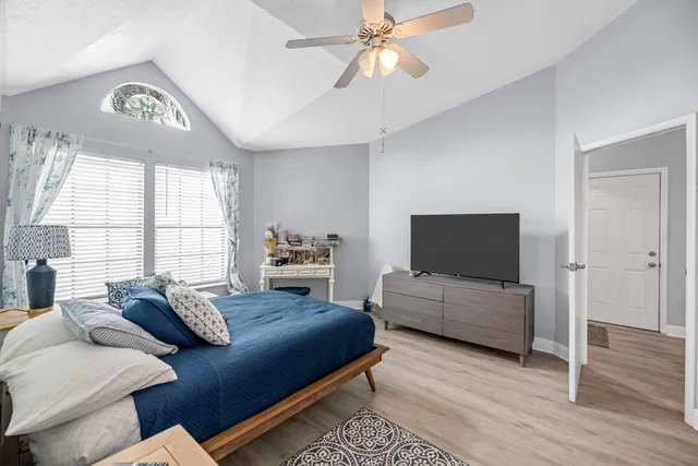 a bedroom with furniture and a flat screen tv