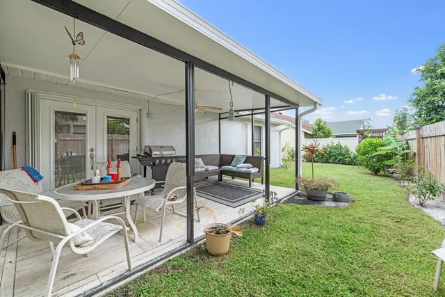 a patio with yard table and chairs