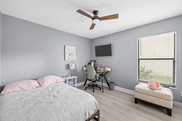 a bedroom with a bed and a chair