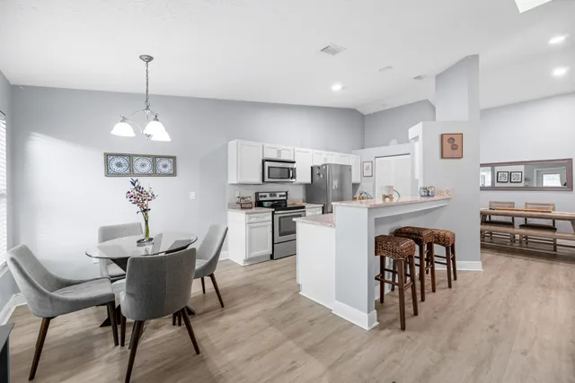 a dining room with furniture and wooden floor