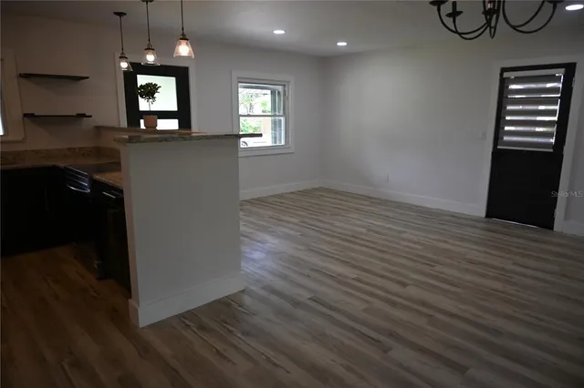 a view of a livingroom with furniture and a window