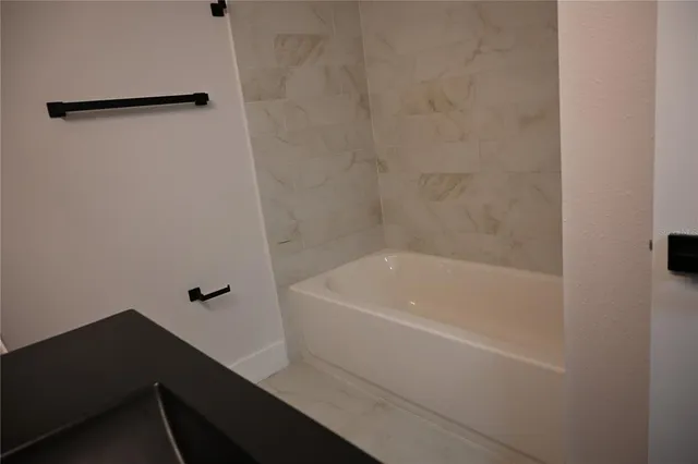 an empty room with wooden floor closet and windows