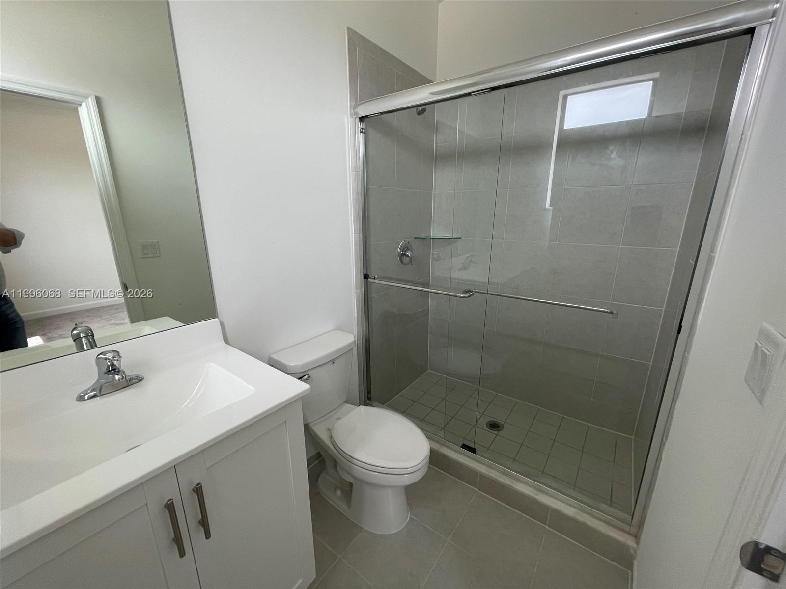 13262 Southwest 287th Terrace Homestead, FL 33033 - Photo 16 of 33 a bathroom with a shower sink vanity mirror and toilet
