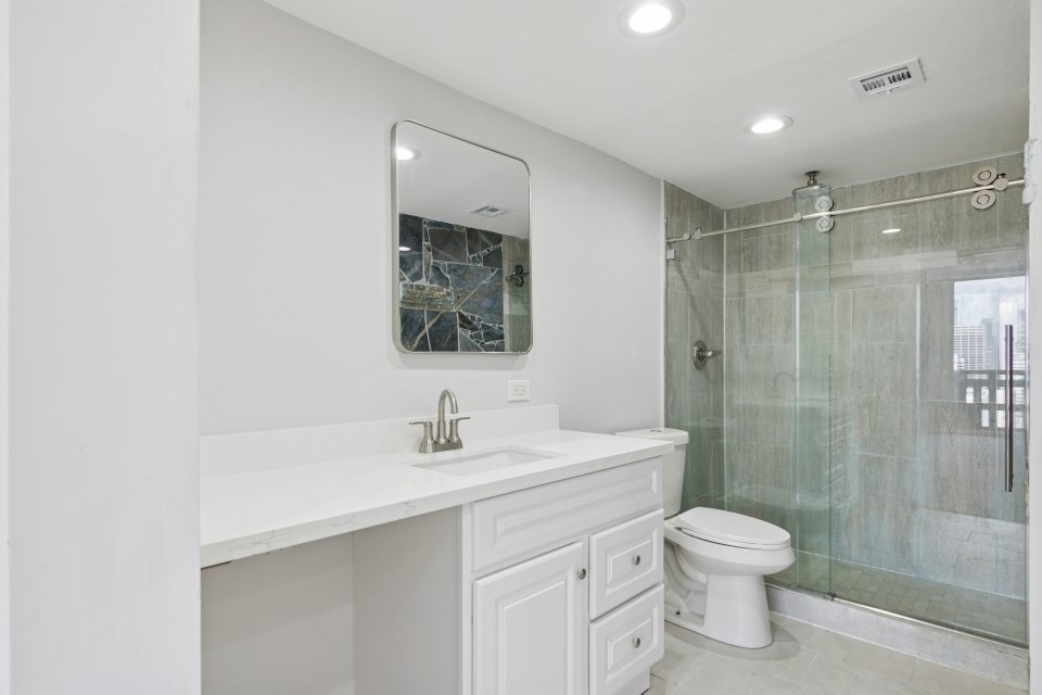 2016 Main Street, Unit 2507 Houston, TX 77002 - Photo 14 of 32 a bathroom with a toilet sink and shower