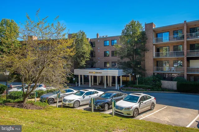 a front view of residential houses with yard and swimming pool