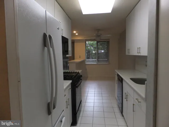 a kitchen with white cabinets and a sink