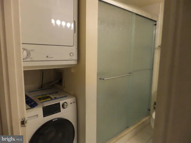 a view of a chair and table in backyard of the house