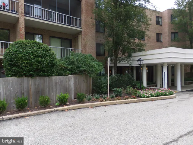 a view of a hallway with a white walls and stairs
