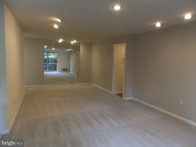 a kitchen with a sink a refrigerator and a stove top oven