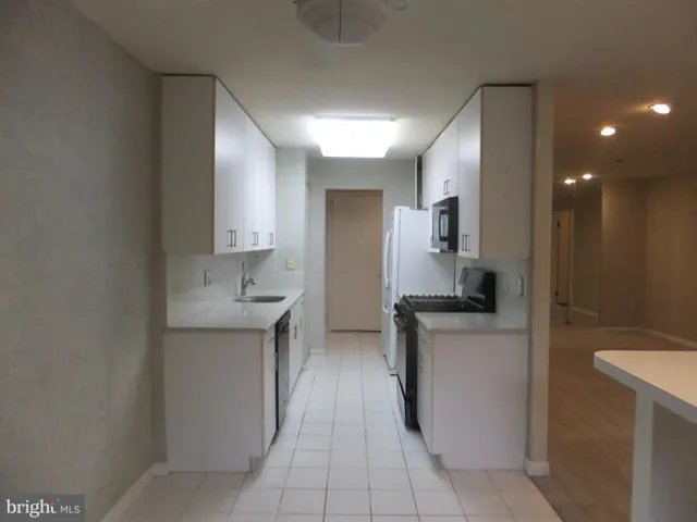 a kitchen with a stove and a white cabinets