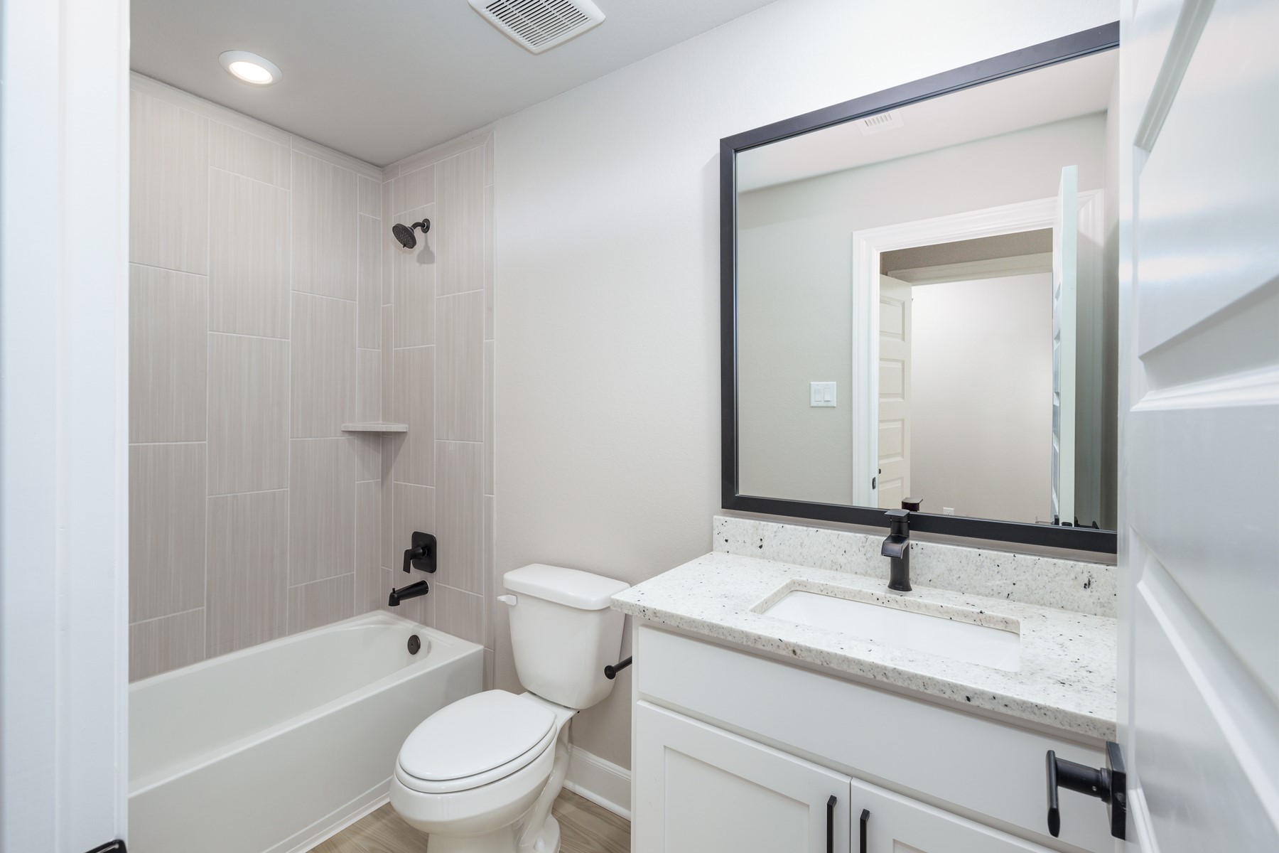 1918 June Lk Lane Iowa Colony, TX 77583 - Photo 6 of 11 a bathroom with a granite countertop sink a toilet and a bathtub
